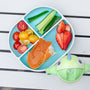 Nuby Rectangular Silicone Suction Plate in aqua holding fruits and vegetables, next to a Dino Clik-It Silicone Straw Trainer Cup.