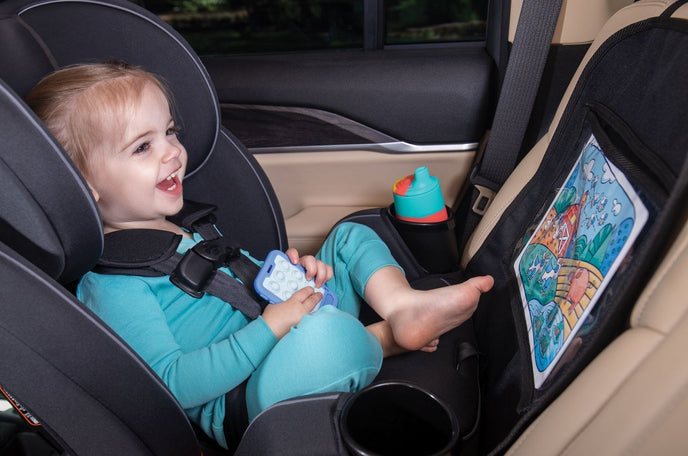 Toddler in rear facing car seat with Nuby x Safe in the Seat protective seat cover.