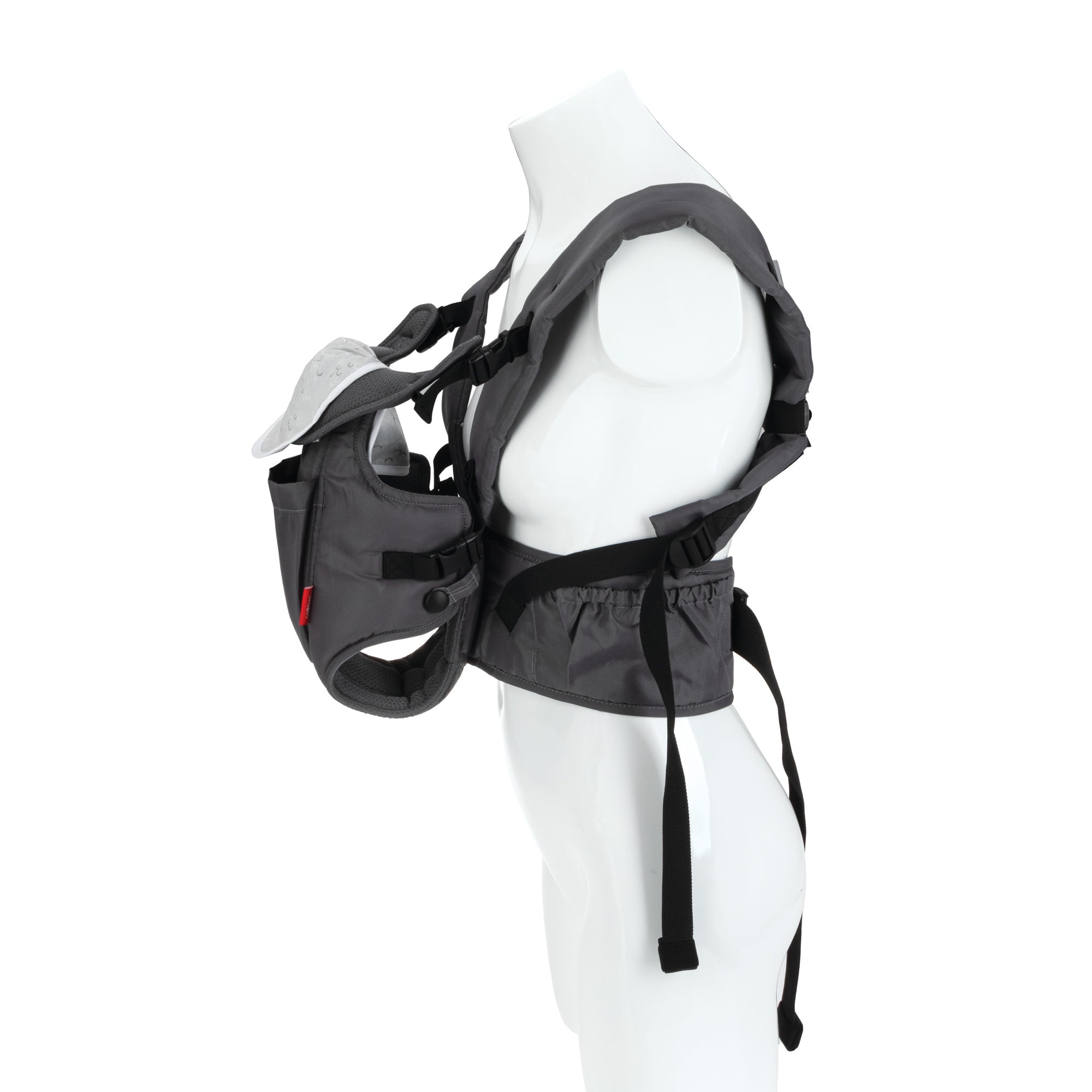 A side view of the Nuby Deluxe Baby Carrier | Grey, shown on a white mannequin torso. Designed for newborns to toddlers, it features adjustable straps, a head cover, and padded support for comfort and safety.