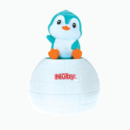 The Nuby Penguin Pop-Up Bath Toy features a blue and white penguin with orange feet and beak on an igloo-shaped base, perfect for encouraging hand-eye coordination during bath time.