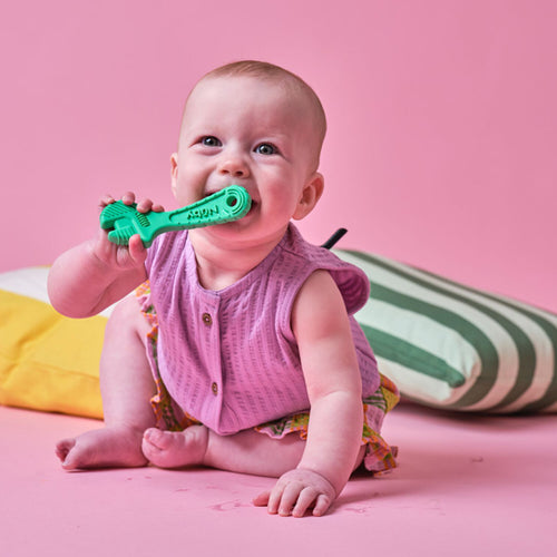 Infant playing with Nuby teether.