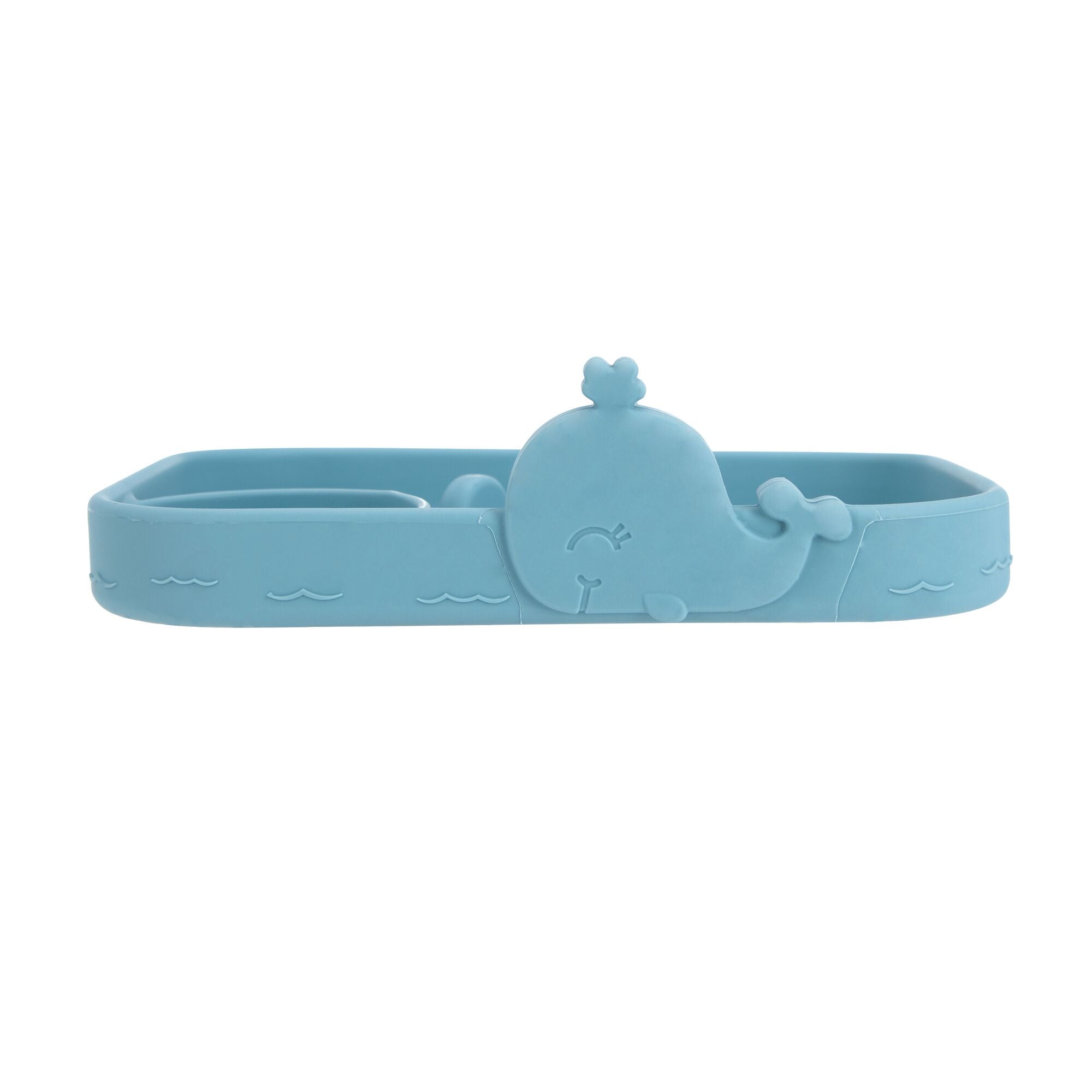 The Animal Friends All Silicone Tray is a blue whale-shaped silicone food tray with embossed wave patterns and a smiling whale, ideal as a baby plate for self-feeding or holding snacks and small items.