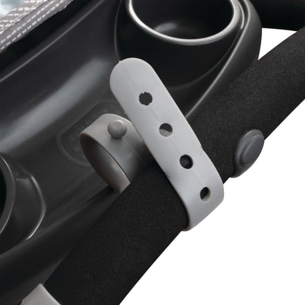 Close-up of Nuby Non-Slip Stroller Hooks (2 Pack) in grey on a stroller handle, showing the adjustable strap, button, and hooks beside cup holders and tray; made of plastic and foam.