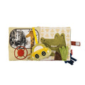 The Baby Sensory Book | City Bus features city scenes with a giraffe, a smiling crocodile, a plush yellow car, and textured green and brown fabrics on a white background—perfect as a tummy time toy for babies.