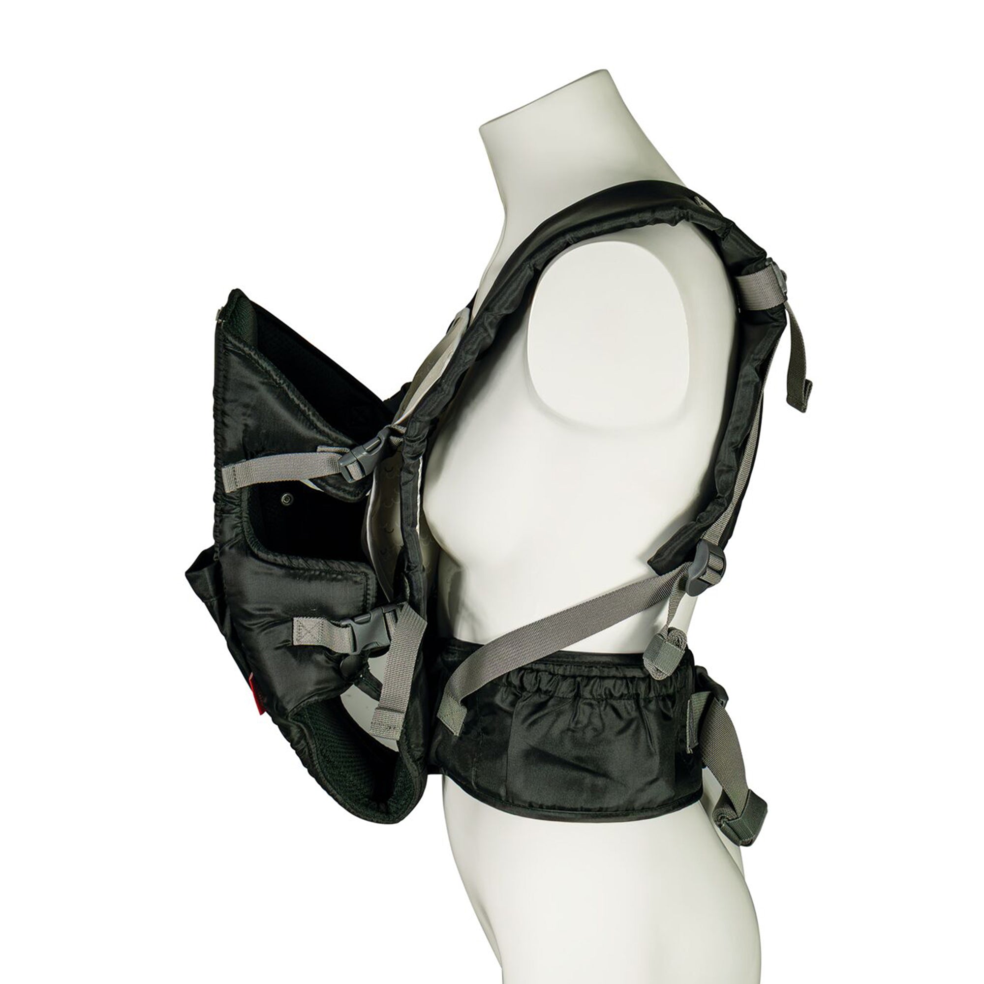 A mannequin torso displays the Deluxe Baby Carrier | Black, featuring padded lumbar support, adjustable straps, and buckles. Shown from the side with the front section open.