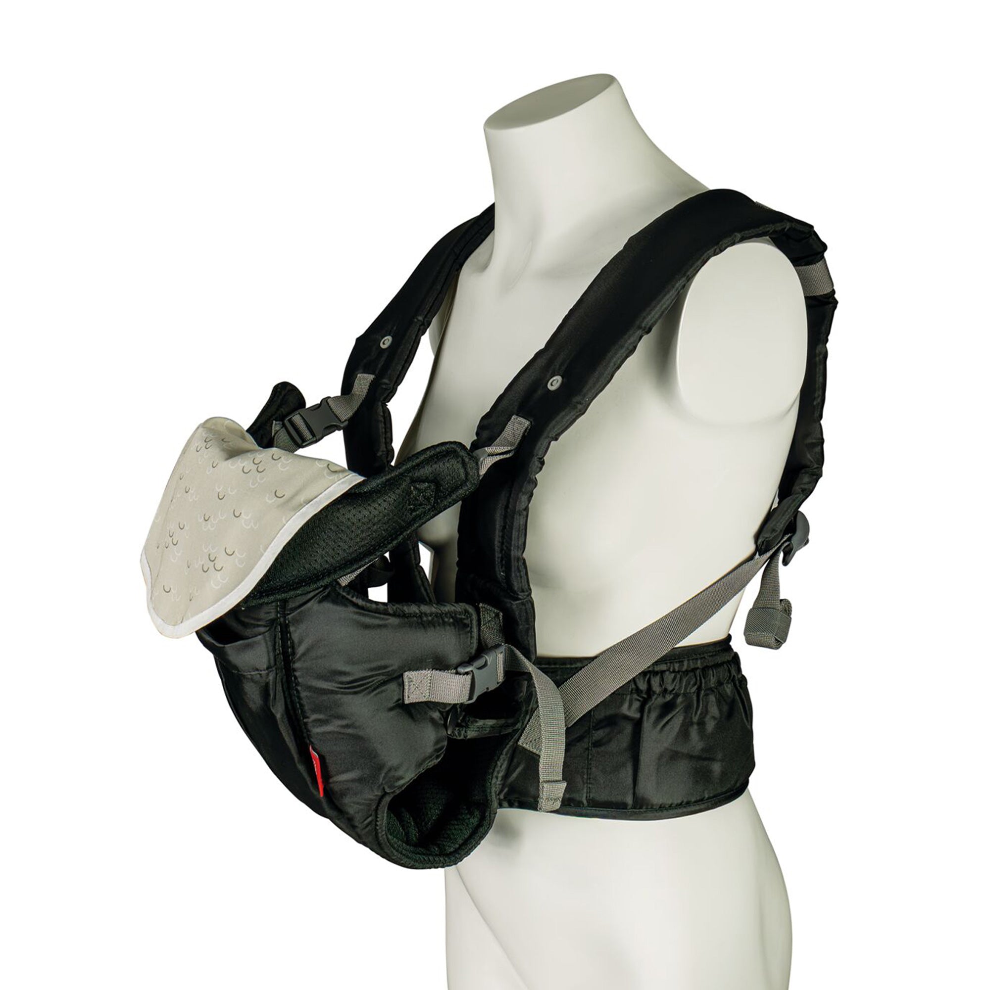 The Deluxe Baby Carrier | Black is shown on a mannequin, featuring padded and adjustable shoulder straps, a waist belt, and a white patterned cloth on the front where the baby sits.