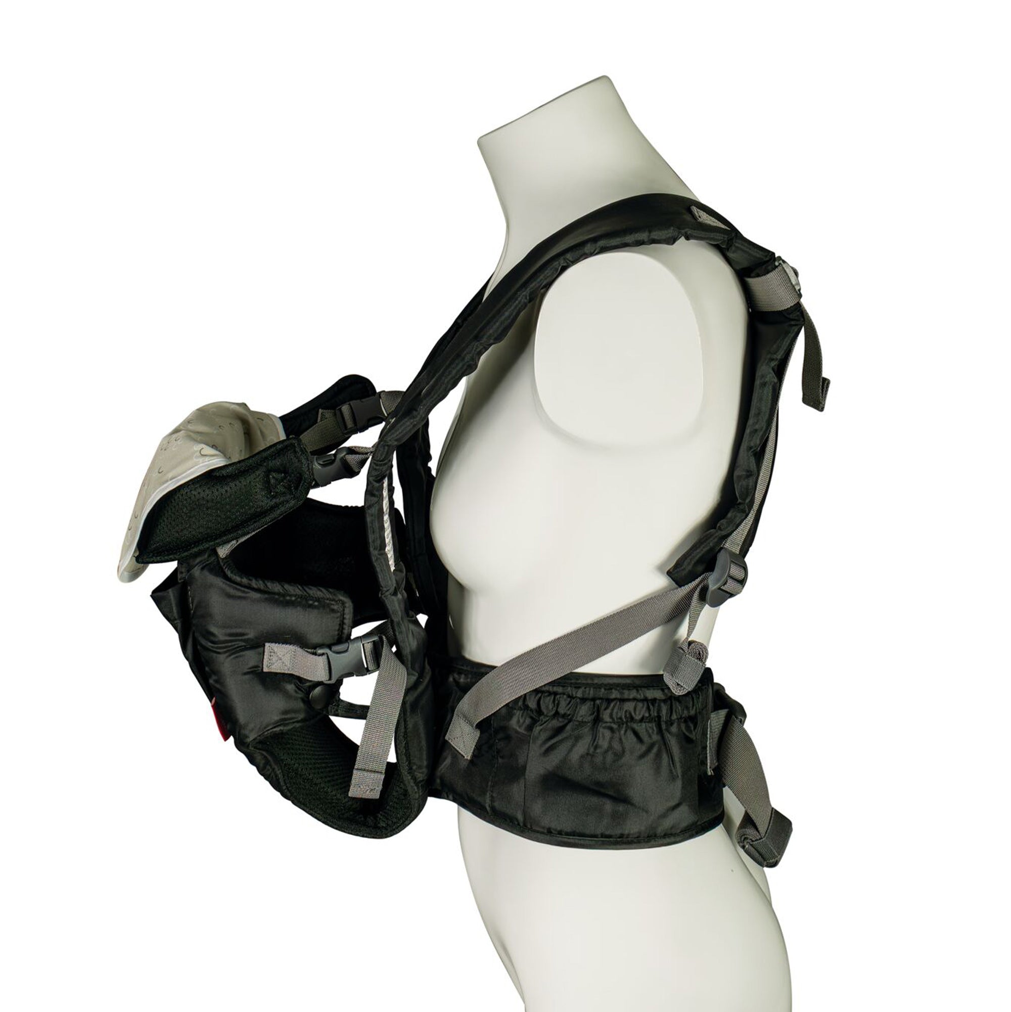 A mannequin models the Deluxe Baby Carrier | Black with adjustable straps, holding a small, white-capped baby doll facing inward on the chest and providing lumbar support for comfort.