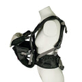 A mannequin models the Deluxe Baby Carrier | Black with adjustable straps, holding a small, white-capped baby doll facing inward on the chest and providing lumbar support for comfort.