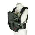 A white mannequin models the Deluxe Baby Carrier | Black, featuring adjustable straps, lumbar support, side buckles, and front-facing pockets. The empty carrier is displayed in a three-quarter view.