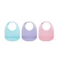 Three Silicone Feeding Bibs (3 Pack) in Aqua, Purple, and Pink are displayed side by side, each featuring an adjustable neck strap and a crumb catcher pocket at the bottom to catch food.
