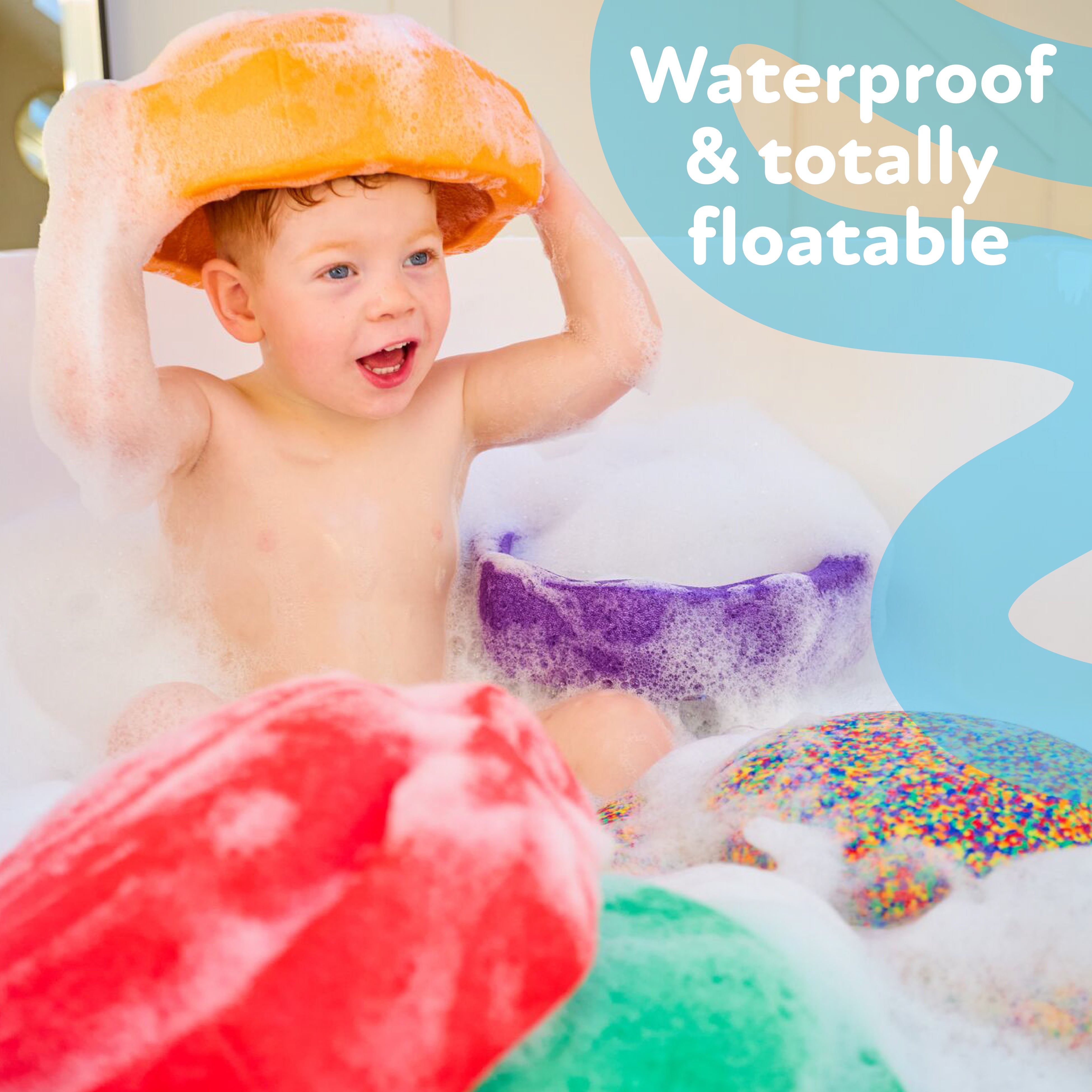 A child in a bubbly bath holds a large orange StepPebbles and FREE Balance Board | Pastel toy overhead, surrounded by colorful, foamy stepping stones. Text: “Waterproof & totally floatable.” Great for indoor and outdoor play.