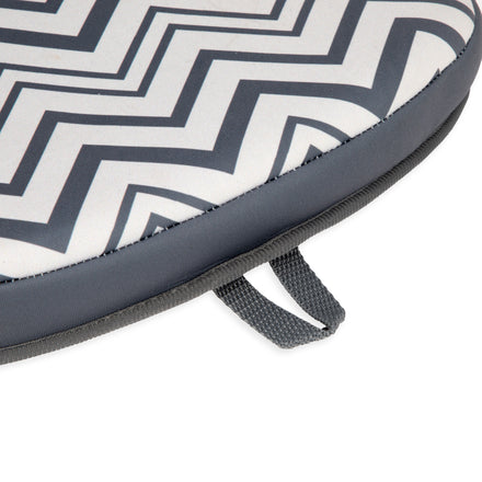The Padded Bathtub Knee Rest features a close-up of its gray and white zigzag padded design, gray edging, and convenient fabric handle—perfect for comfortable support during baby bath time.