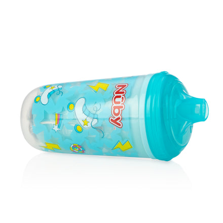 A Nuby Insulated Light-Up Easy Sip Cup with a No Spill bite resistant spout, featuring white unicorns, yellow lightning bolts, stars, and rainbows, lies sideways on a white background and keeps drinks cool.