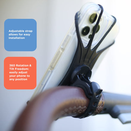 The Nuby Silicone Stroller Phone Holder (2 Pack) in black easily attaches to handlebars with an adjustable strap and offers 360° rotation, allowing flexible smartphone positioning.